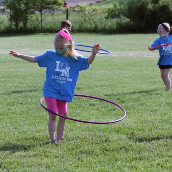 student outdoors hula hooping